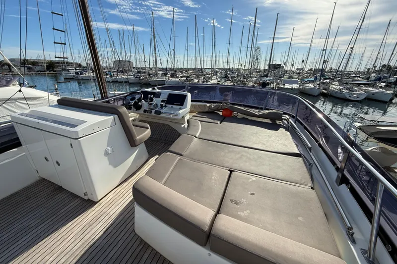  Yacht Photos Pics Flybridge of 2017 Prestige 560 Fly yacht in marina, featuring helm and seating area.