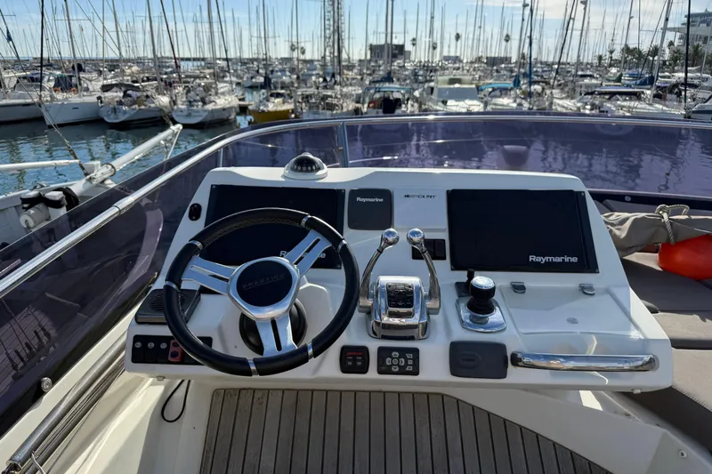  Yacht Photos Pics Flybridge helm of 2017 Prestige 560 Fly yacht with Raymarine navigation system.
