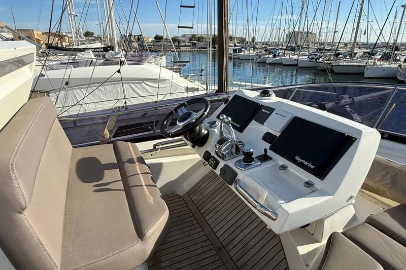  Yacht Photos Pics Flybridge helm of 2017 Prestige 560 Fly yacht with marina view.