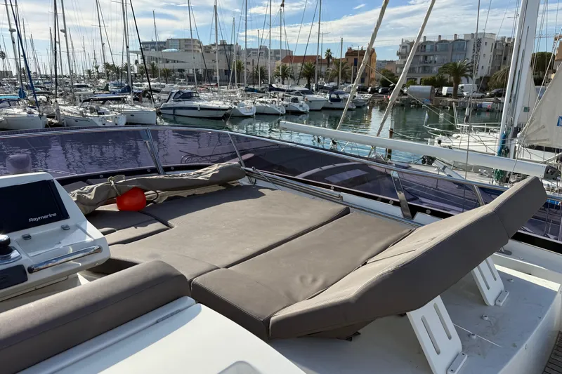  Yacht Photos Pics Prestige 560 Fly 2017 yacht with sunbathing area in marina setting.