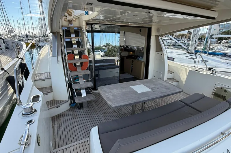  Yacht Photos Pics 2017 Prestige 560 Fly yacht with outdoor seating and marina view.