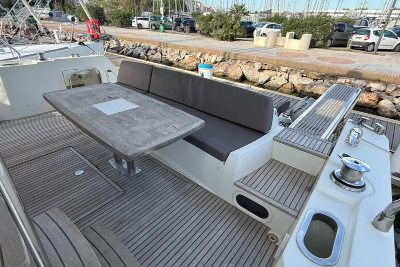  Yacht Photos Pics Prestige 560 Fly 2017 yacht deck with seating and table, docked at marina.