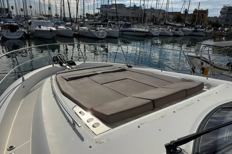  Yacht Photos Pics 2017 Prestige 560 Fly yacht with sunbathing area, docked in a marina.