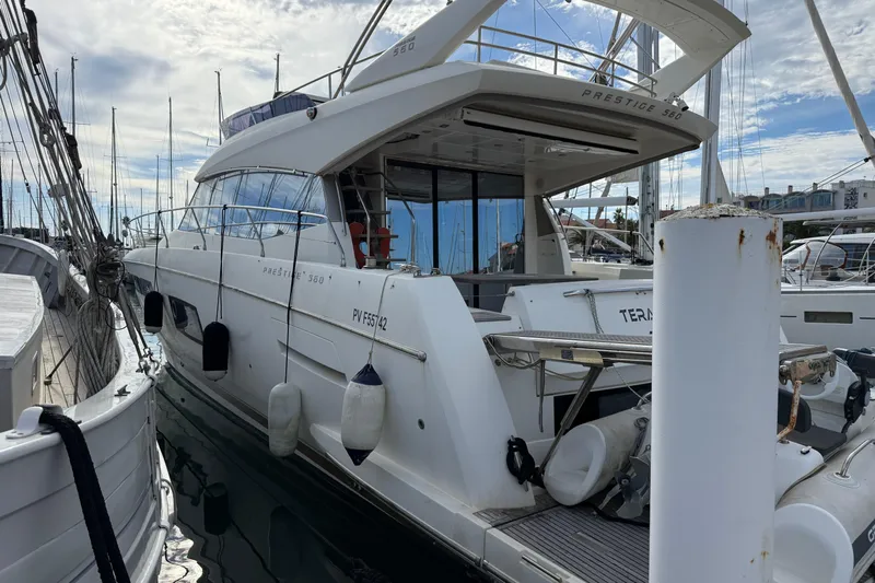  Yacht Photos Pics 2017 Prestige 560 Fly yacht docked in marina, surrounded by other boats.