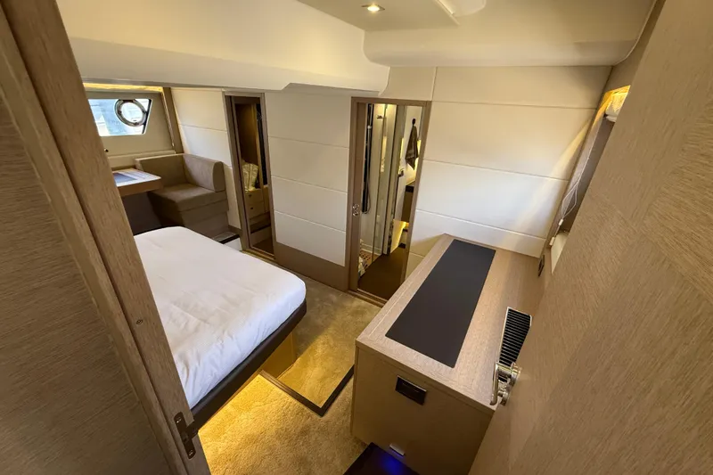  Yacht Photos Pics Luxurious interior of 2017 Prestige 560 Fly yacht, featuring a cozy bedroom and seating area.