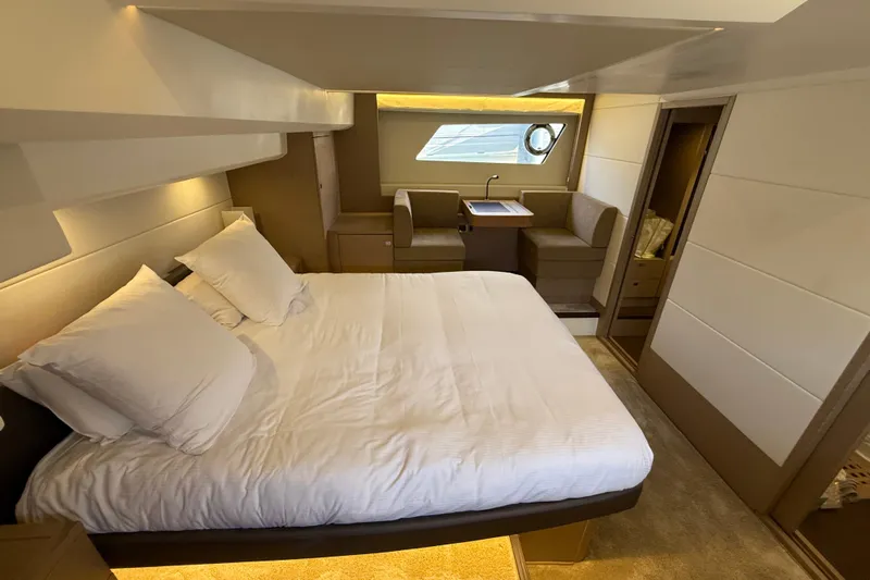 Yacht Photos Pics Luxurious bedroom interior of 2017 Prestige 560 Fly yacht, featuring elegant design and comfortable furnishings.