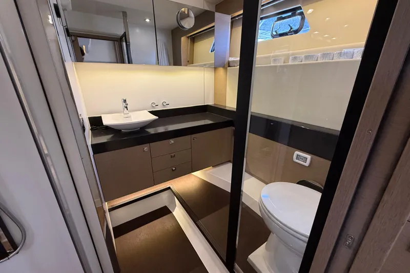  Yacht Photos Pics Luxurious bathroom interior of 2017 Prestige 560 Fly yacht, featuring modern fixtures and elegant design.
