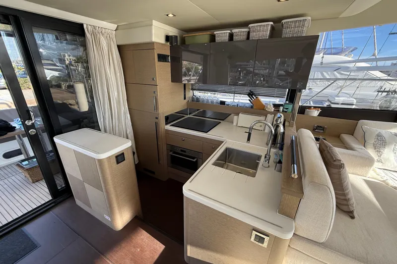  Yacht Photos Pics Luxurious interior of 2017 Prestige 560 Fly yacht with modern kitchen and seating area.