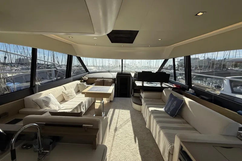  Yacht Photos Pics Luxurious interior of a 2017 Prestige 560 Fly yacht with elegant seating and panoramic windows.