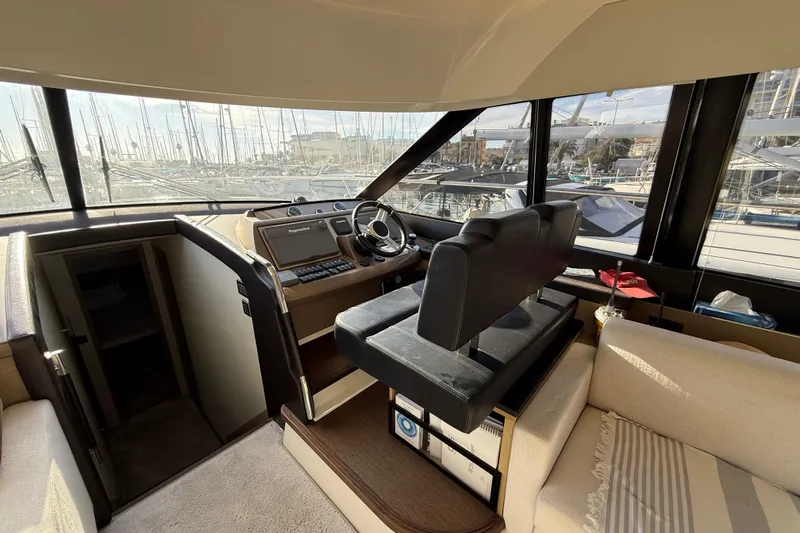  Yacht Photos Pics Interior of 2017 Prestige 560 Fly yacht with helm station and panoramic windows.