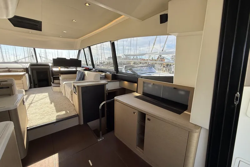  Yacht Photos Pics Luxurious interior of a 2017 Prestige 560 Fly yacht with modern furnishings and large windows.