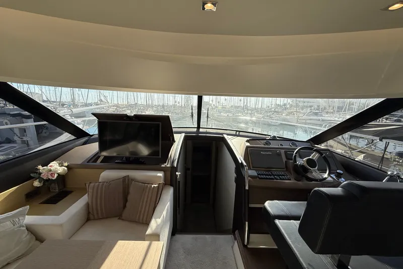  Yacht Photos Pics Luxurious interior of 2017 Prestige 560 Fly yacht with helm, seating, and marina view.