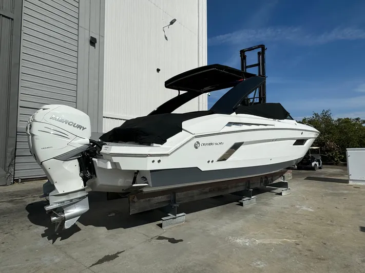 Pieseas Yacht Photos Pics 2019 Cruisers Yachts 338 Outboard, white, docked outdoors, featuring twin Mercury engines.