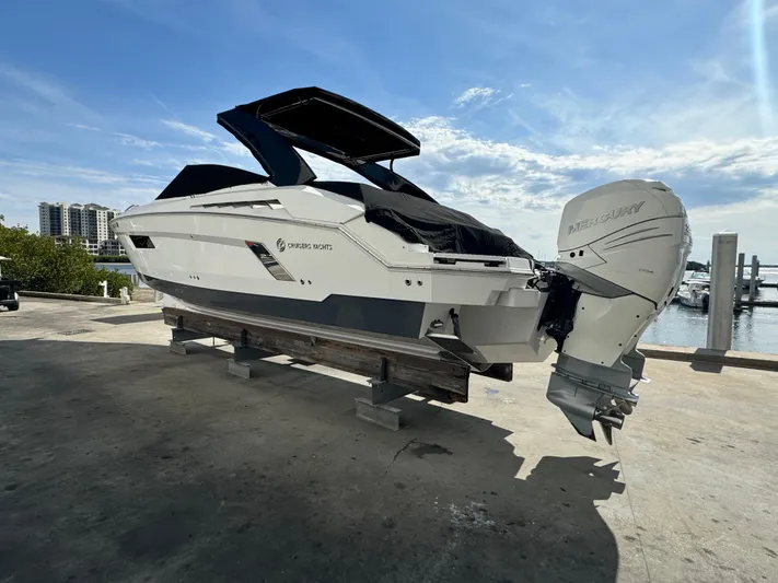 Pieseas Yacht Photos Pics 2019 Cruisers Yachts 338 Outboard on dock, sunny marina background.