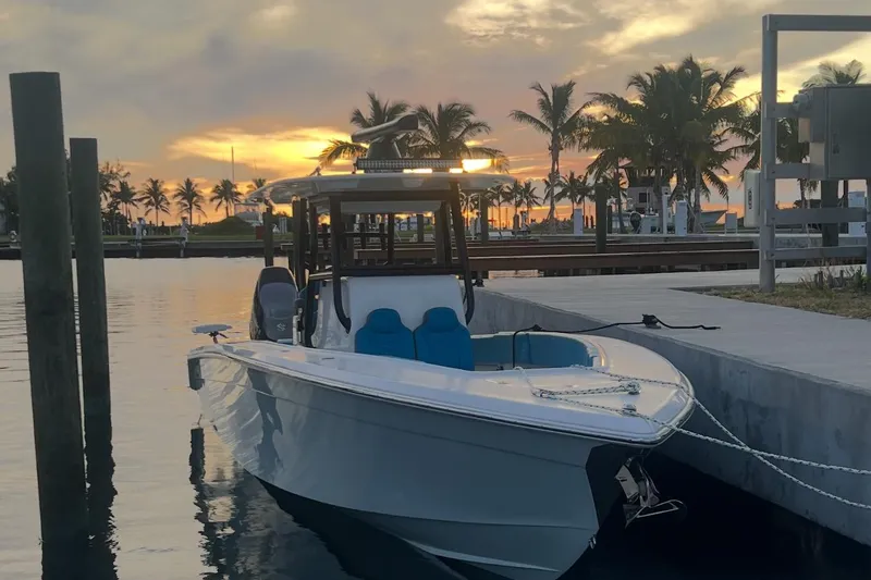  Yacht Photos Pics 2023 Sea Tech 33 CC boat docked at sunset with palm trees in the background.