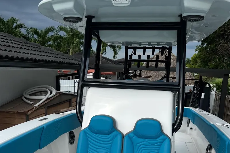  Yacht Photos Pics 2023 Sea Tech 33 CC boat with blue seating and sleek design.