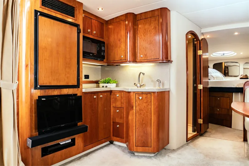 Hadi Yacht Photos Pics Luxurious 2005 Cruisers Yachts 370 Express interior with elegant wood cabinetry and modern amenities.