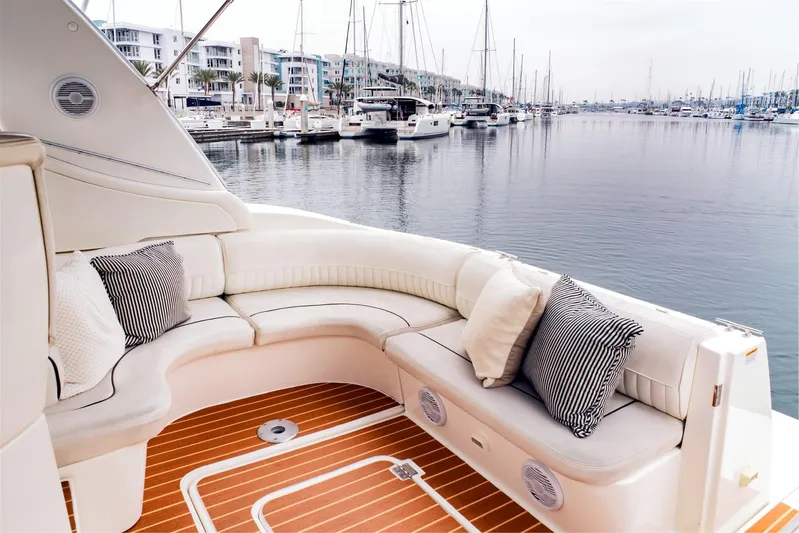 Hadi Yacht Photos Pics Luxurious 2005 Cruisers Yachts 370 Express with elegant seating, docked in a serene marina.