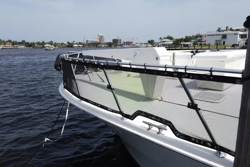 Marlintini Yacht Photos Pics 1999 Viking Cockpit Motoryacht docked on a calm waterfront with cityscape in the background.