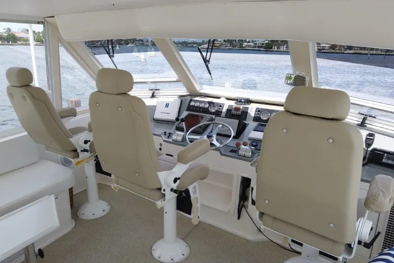 Marlintini Yacht Photos Pics 1999 Viking Cockpit Motoryacht helm with beige seats and navigation controls.