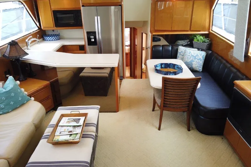 Marlintini Yacht Photos Pics Luxurious interior of a 1999 Viking Cockpit Motoryacht with modern kitchen and cozy seating area.