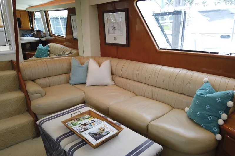Marlintini Yacht Photos Pics Luxurious interior of a 1999 Viking Cockpit Motoryacht with plush seating and decorative pillows.