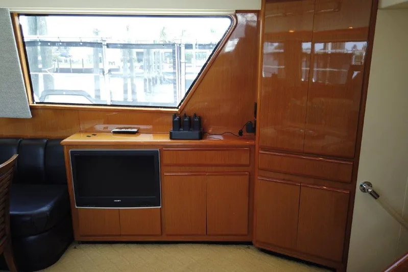 Marlintini Yacht Photos Pics 1999 Viking Cockpit Motoryacht interior with wood cabinetry and built-in TV.