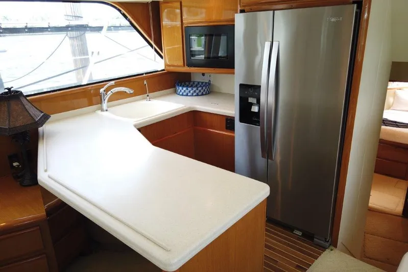 Marlintini Yacht Photos Pics 1999 Viking Cockpit Motoryacht kitchen with modern appliances and sleek countertops.
