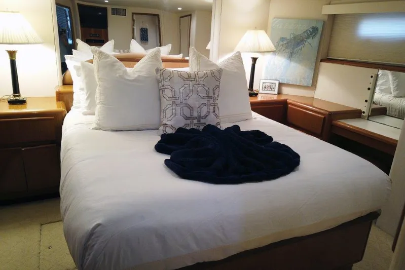 Marlintini Yacht Photos Pics Luxurious bedroom interior of 1999 Viking Cockpit Motoryacht with elegant bedding and soft lighting.