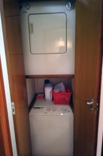 Marlintini Yacht Photos Pics Laundry area in 1999 Viking Cockpit Motoryacht with stacked washer and dryer.