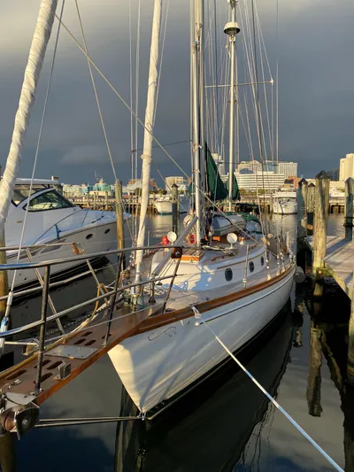 Isabella II Yacht Photos Pics 1988 Shannon 43 sailboat docked at marina, under cloudy sky.