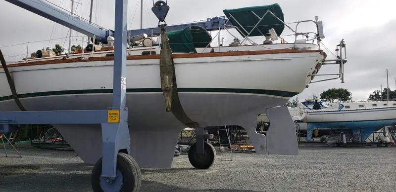 Isabella II Yacht Photos Pics Sailboat on lift, Shannon 43 model, 1988, in a boatyard setting.