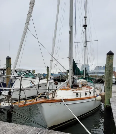 Isabella II Yacht Photos Pics 1988 Shannon 43 sailboat docked at marina, overcast sky, wooden deck, nautical setting.