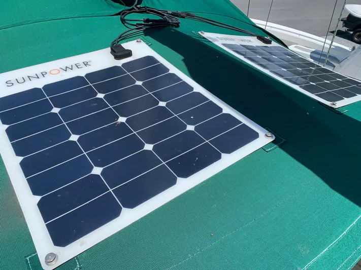 Isabella II Yacht Photos Pics SunPower solar panels on a 1988 Shannon 43 boat, mounted on a green surface.