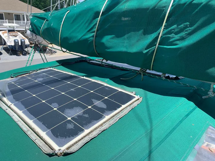Isabella II Yacht Photos Pics Solar panel on 1988 Shannon 43 sailboat with green cover.