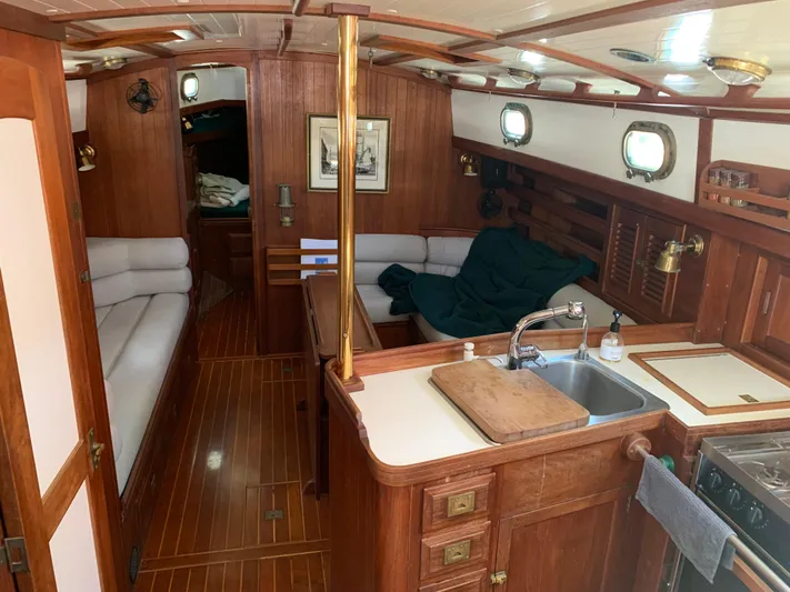 Isabella II Yacht Photos Pics 1988 Shannon 43 yacht interior with wood finish, kitchen, and seating area.