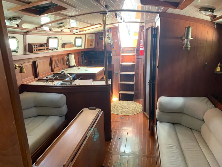 Isabella II Yacht Photos Pics Interior of 1988 Shannon 43 yacht with wooden finish and cozy seating area.