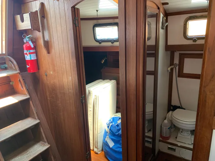 Isabella II Yacht Photos Pics Interior of 1988 Shannon 43 sailboat with wooden paneling and compact bathroom.