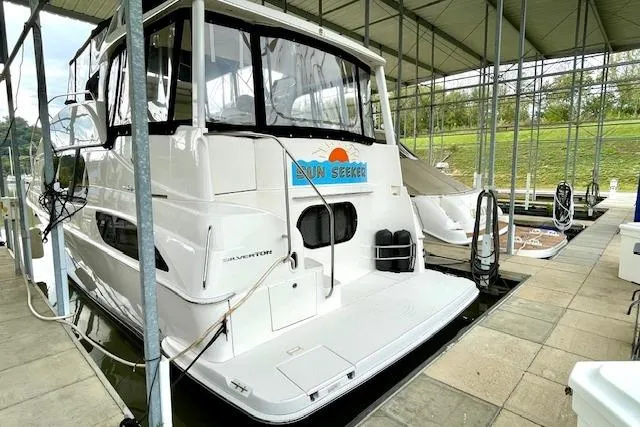 "sunseeker" Yacht Photos Pics 2002 Silverton 43 Motor Yacht docked under a covered marina.