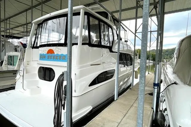 "sunseeker" Yacht Photos Pics 2002 Silverton 43 Motor Yacht docked in a covered marina.