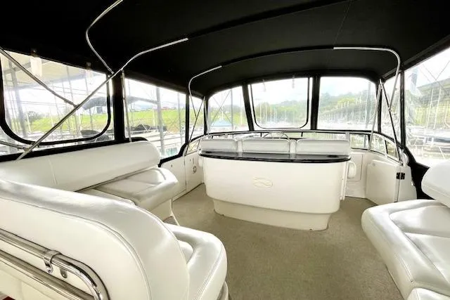 "sunseeker" Yacht Photos Pics Interior of 2002 Silverton 43 Motor Yacht with white seating and panoramic windows.