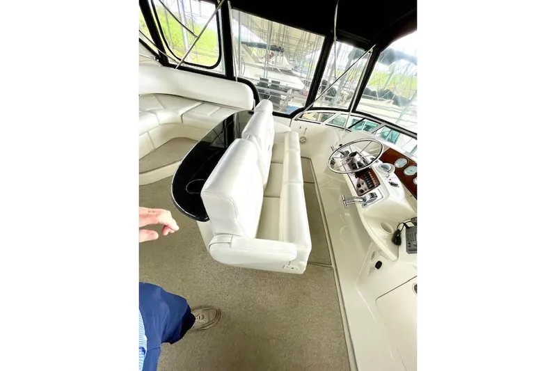 "sunseeker" Yacht Photos Pics Interior of 2002 Silverton 43 Motor Yacht with white seating and steering console.