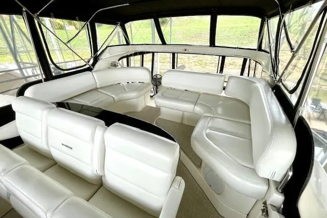 "sunseeker" Yacht Photos Pics 2002 Silverton 43 Motor Yacht interior with white leather seating and panoramic windows.