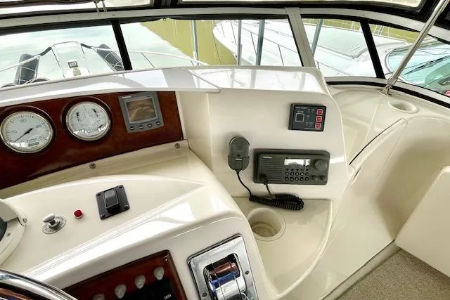 "sunseeker" Yacht Photos Pics 2002 Silverton 43 Motor Yacht helm with gauges, controls, and navigation equipment.