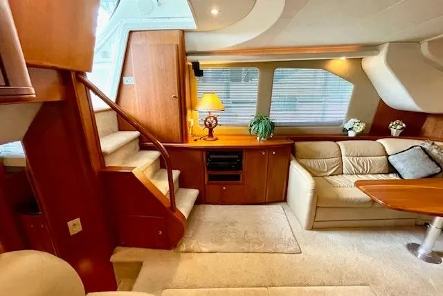 "sunseeker" Yacht Photos Pics Luxurious interior of 2002 Silverton 43 Motor Yacht with elegant wood finishes and cozy seating.
