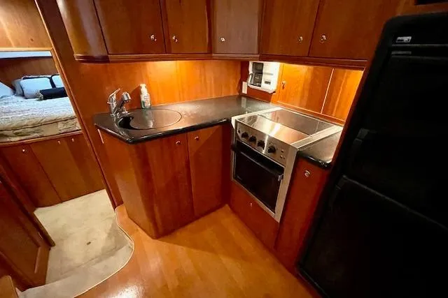 "sunseeker" Yacht Photos Pics 2002 Silverton 43 Motor Yacht kitchen with wood cabinetry and modern appliances.