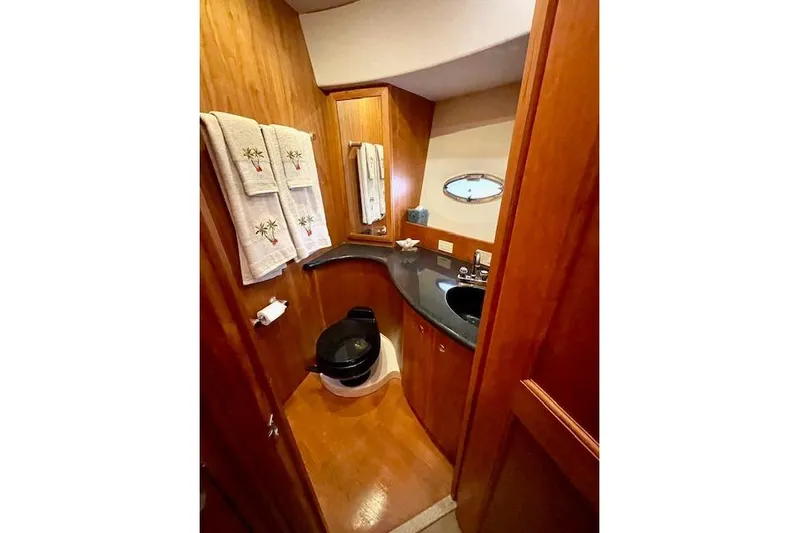 "sunseeker" Yacht Photos Pics Luxurious bathroom in 2002 Silverton 43 Motor Yacht with wood accents and modern fixtures.