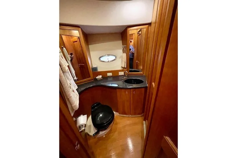 "sunseeker" Yacht Photos Pics Luxurious bathroom in 2002 Silverton 43 Motor Yacht with wood cabinetry and modern fixtures.