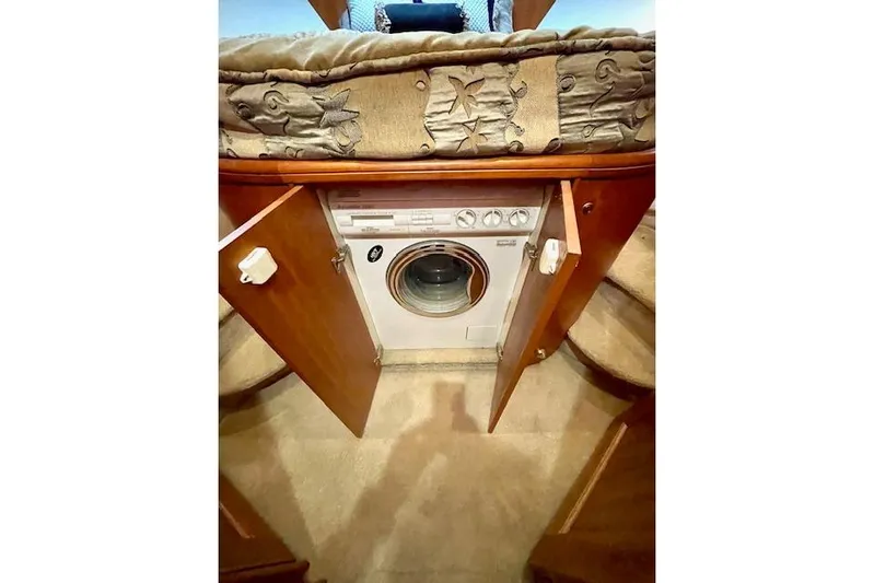 "sunseeker" Yacht Photos Pics 2002 Silverton 43 Motor Yacht interior with built-in washing machine under bed.