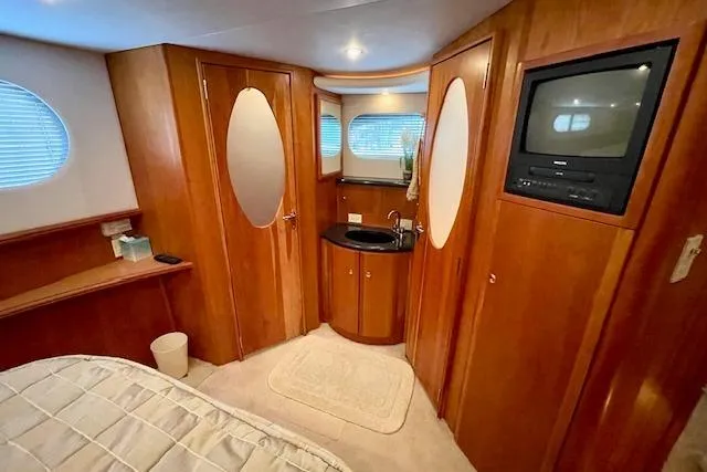 "sunseeker" Yacht Photos Pics Interior of 2002 Silverton 43 Motor Yacht with wood paneling and built-in TV.